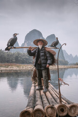 Wall Mural - A traditional cormorant fisherman works on the Li River Yangshuo, China.