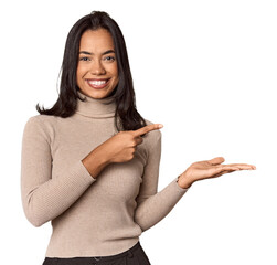 Wall Mural - Young filipino woman excited holding a copy space on palm.