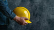 © Shanorsila - Male hand holding yellow construction hat