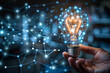 © Nathasa - Close up human hand with light bulb with hologram data background.