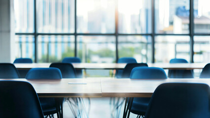 Interior of urban business conference room or university classroom with blue chairs, empty tables and bright lighting