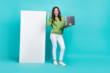 Poster - Full length portrait of delighted person wireless netbook raise fist celebrate isolated on turquoise color background