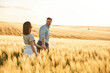 © standret - Leading the way, holding hands. Lovely beautiful couple are together on the agricultural field