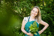 © epiximages - pretty, attractive woman in her early 40s, collects wild herbs in the garden, meadow, forest for a salad, for cooking, eating, for smoothies
