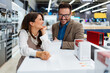 © Dusko - Beautiful and happy middle age couple buying consumer tech products in modern home appliances store. They are choosing washing or cloth dryer machine. People and consumerism concept.
