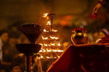 Wall Mural - Ganga aarti, Fire flame at night with dark background during the ganga aarti rituals at river bank of Varanasi.