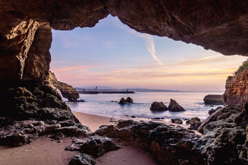 Wall Mural - View of Lagos marina entrance at sunrise from the rocky coastline at Praia dos Estudantes Beach, Lagos, Algarve, Portugal	