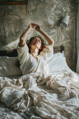 Poster - A woman laying in bed with her arms raised. Suitable for lifestyle or relaxation concepts