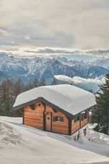 Wall Mural - Snow-covered cabin nestled in the mountains. Bettmeralp, Switzerland