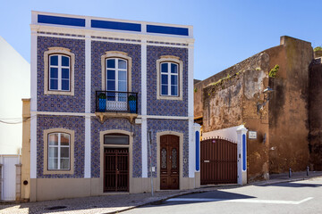 Blue and yellow tile facade refurbished neoclassical house on Rua da Atalaia street in the old town, , Lagos, Portugal