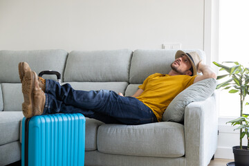 Man resting in the living room of their house until it's time to go to the airport. Man resting on the couch waiting for their flight time. Man or woman on vacation has just arrived at the hotel.