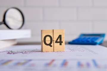 Close up image of wooden cubes with alphabet Q4 on office desk. Fourth quarter concept.