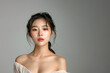 © kanpisut - Portrait of beautiful young aisan woman on gray color background. Cosmetology, beauty, skincare concept.