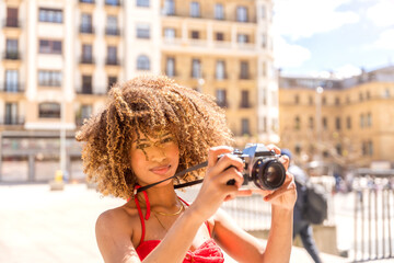 Beauty tourist taking photos while visiting a city