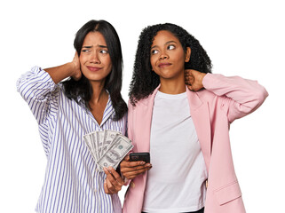 Wall Mural - Latin businesswomen with money, phone touching back of head, thinking and making a choice.