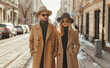 © rohappy - Stylish young couple in autumn brown coat, beautiful woman and man walking along a city street