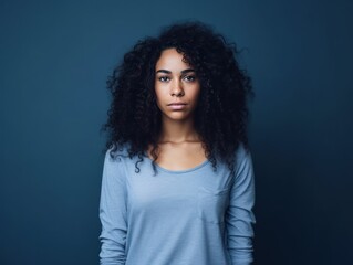 Indigo background sad black independent powerful Woman. Portrait of young beautiful bad mood expression girl Isolated on Background racism skin color depression anxiety fear burn out