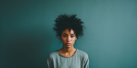 Mint background sad black independent powerful Woman. Portrait of young beautiful bad mood expression girl Isolated on Background racism skin color depression anxiety fear burn out 