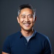 © Zickert - Navy Background Happy asian man. Portrait of older mid aged person beautiful Smiling boy good mood Isolated on Background ethnic diversity