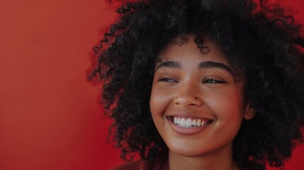 Wall Mural - Attractive Black Girl with Lush Curly Hair Posing for Fashion Magazine Photoshoot. Smiles Playfully, Acts, Plays with Facial Expressions. Professional Studio Photograph.