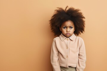 Wall Mural - Beige background sad black American African child Portrait of young beautiful kid Isolated Background racism skin color depression anxiety fear burn out health issue problem mental 