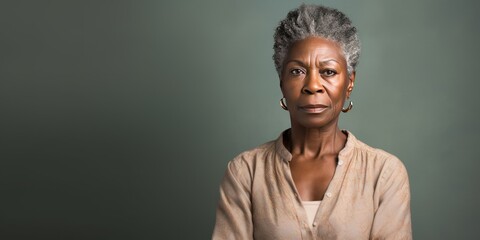 Wall Mural - Beige background sad black American independent powerful Woman. Portrait of older mid-aged person beautiful bad mood expression girl Isolated on Background racism skin color depression 