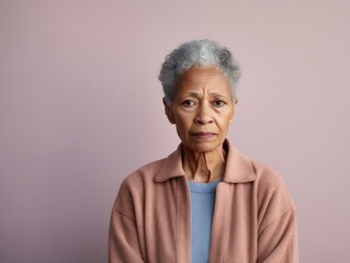 Wall Mural - Beige background sad black American independent powerful Woman. Portrait of older mid-aged person beautiful bad mood expression girl Isolated on Background racism skin color depression 