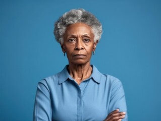 Wall Mural - Blue background sad black American independent powerful Woman. Portrait of older mid-aged person beautiful bad mood expression girl Isolated on 