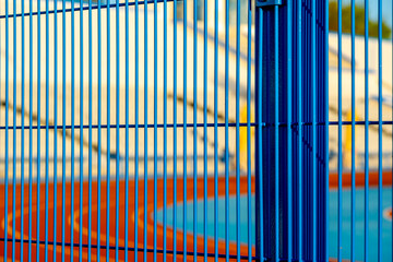 Blue iron grating on the street near the stadium.