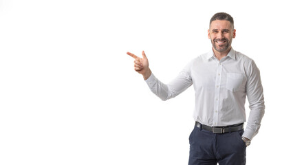 A smiling man dressed in business attire points confidently with his index finger against a clean, white background. The man exudes a professional yet approachable demeanor, copy space