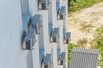 Facade of an office building with many air conditioners on the windows