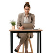 © Exnoi - A woman is sitting at a desk with a laptop and a potted plant, isolated on transparent background