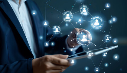 Leinwandbilder - A businessman using a digital tablet to engage with a virtual network of customer and HR icons, demonstrating advanced technology for CRM and recruitment