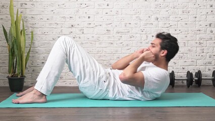 Wall Mural - Tired young and lazy man sleeping while training on the floor at home. Do sport and exercise at the morning time