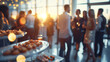 © JMarques - Business event in an office with a crowd of employees. Food and drink in a meeting or conference room with business people in the background. Blurred shot of business people at a party in the office