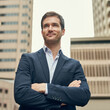 © peopleimages.com - Arms crossed, city and vision with business man outdoor for career, inspiration or opportunity. Future, planning and smile with happy corporate employee outdoor in urban town for professional mindset