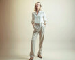 © angelo lano - full length portrait of a beautiful mature woman, wearing casual style blouse and trousers standing on light background,