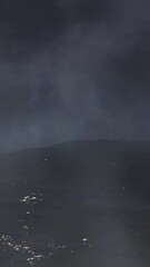 Wall Mural - vertical ocean waves with misty stormy sky 4k loop features a view of a dark ocean with strong waves