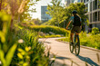 © Ed - Comfortable and accessible urban environment, portrait of a cyclist from the back riding in the park, space for the concept of ecology and development and sustainable inclusive social environment