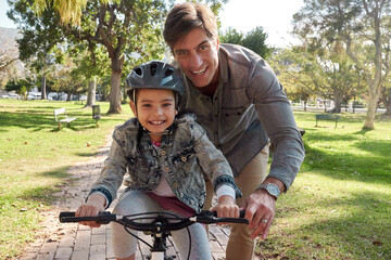 Poster - Father, girl and happy outside on bicycle in nature, support and help for teaching and motor skills for growth. Childhood, development and family in park, bonding and helmet for riding with parent