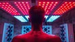 © DZMITRY - An unrecognizable man doing red light therapy with a panel.