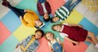 © peopleimages.com - Kids, lying down and circle in school with top view for relax, fun and classroom on colourful foam mat. Group, children and happy on floor for education, learning and knowledge with game for bonding