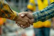 © Sandu - Two men shaking hands at construction site