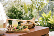 © Natasha Lee - Mediterranean vegetable platter on an outdoor table at a luxury resort served with warm pita in a basket and iced cocktail.