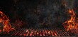 © Vasiliy - Hot empty portable barbecue BBQ grill with flaming fire and ember charcoal on black background