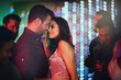 © peopleimages.com - Couple, love and dance in club at night on date with romance in marriage or relationship. People, celebrate and embrace together with happiness at neon disco, party or rave at techno music festival