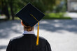 © Михаил Решетников - A woman throws her graduation cap against the blue sky.