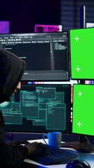 Wall Mural - Vertical video Hacker developing spyware software on green screen computer to steal important data to be sold on black market. Hooded scammer writing malicious code on chroma key PC, camera B