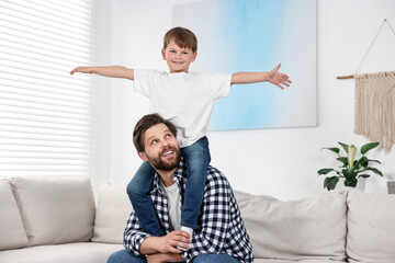 Canvas Print - Happy dad and son having fun at home