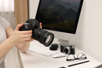 Canvas Print - Photographer with camera at white table indoors, closeup